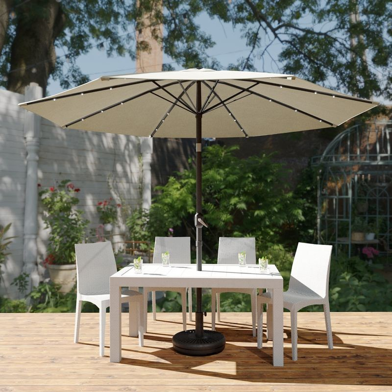LeisureMod Sierra Outdoor Patio Umbrella with Base in Cream Outside.
