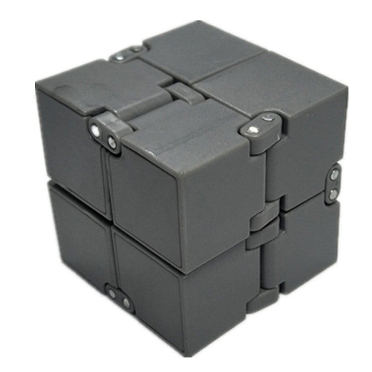 Gray fidget cube on a white background.