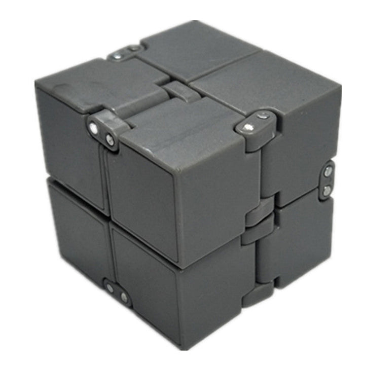 Gray fidget cube on a white background.