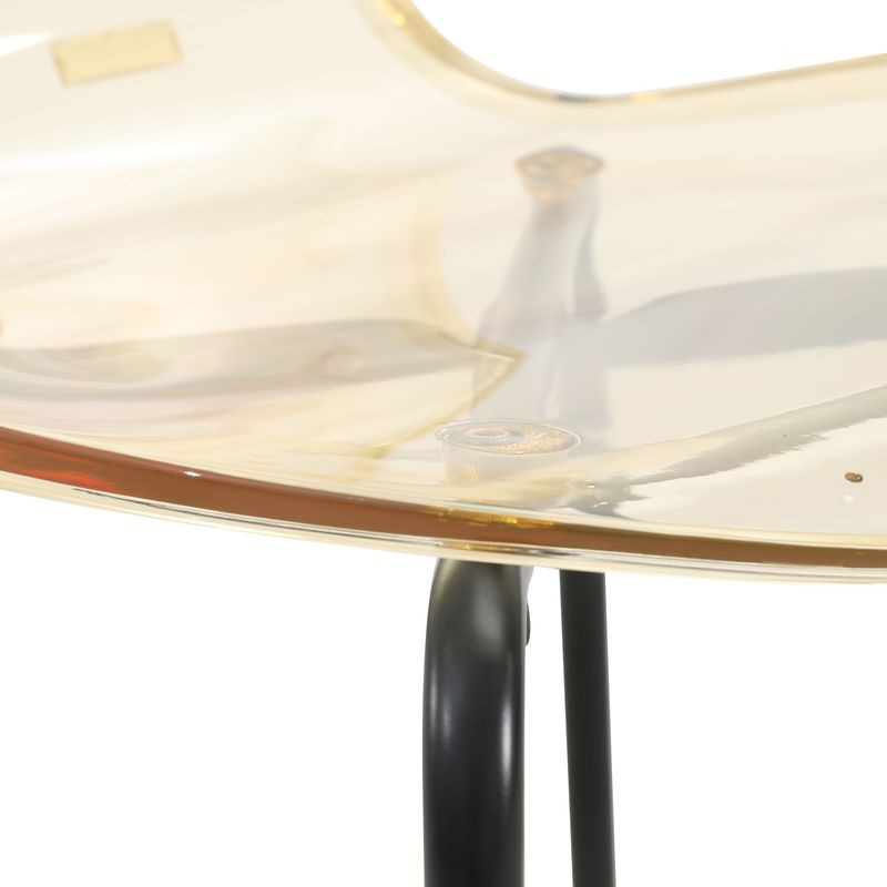 Close-up of a chair with a transparent backrest and black metal legs on a white background.