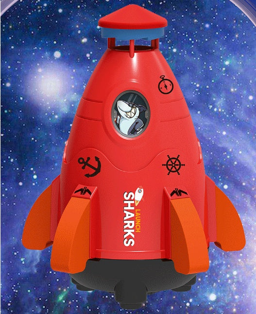 Toy rocket ship with cartoon character on a space themed background.