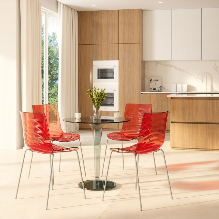LeisureMod Astor Water Ripple Design Dining Chair Transparent Red at Table.