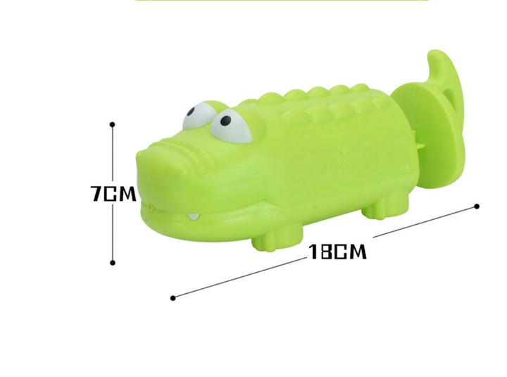 Green alligator toy with measurements on a white background.