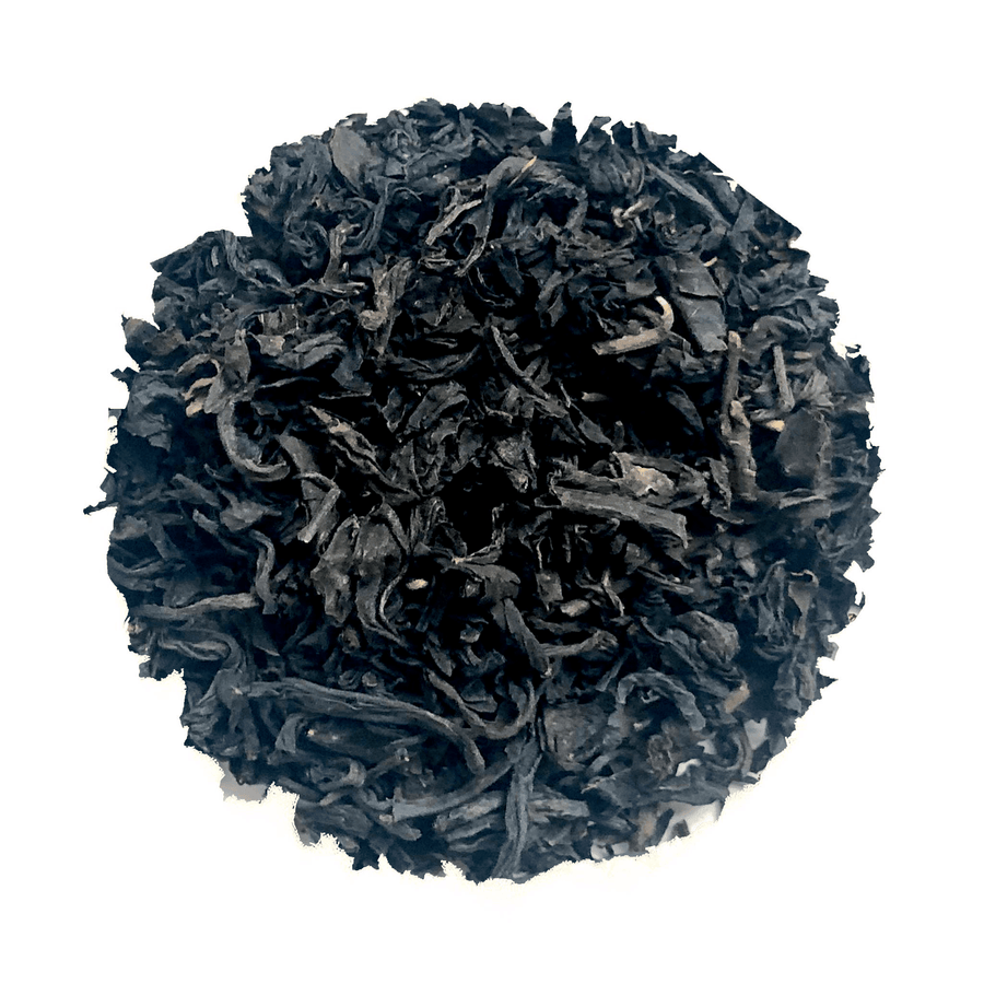 Black tea leaves on a white background.