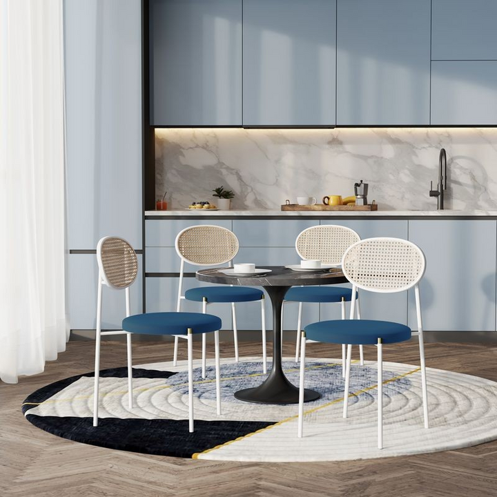 LeisureMod 5-Piece Dining Set with 36" Round Dining Table Black Sintered Stone Top and Black Pedestal with 4 Velvet Dining Chairs in White Steel Legs in Navy Blue in Room.