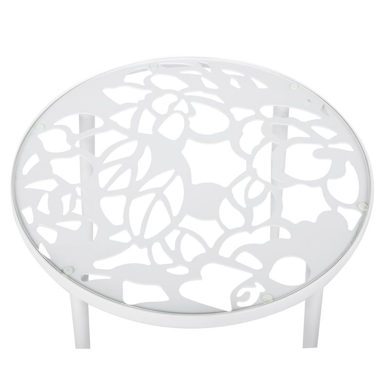 White round metal table with decorative cut-out design on a white background