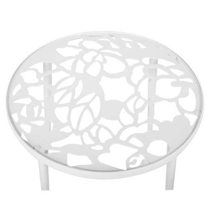 White round metal table with decorative cut-out design on a white background
