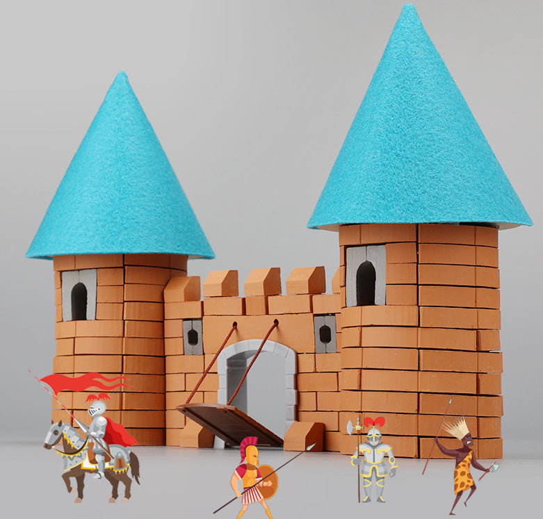 Toy castle with blue towers and small figures on a gray background.
