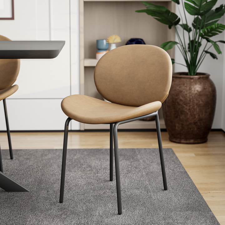 LeisureMod Servos Modern Dining Side Chair with Upholstered Faux Leather Seat and Powder Coated Iron Frame Sand Brown at Table.
