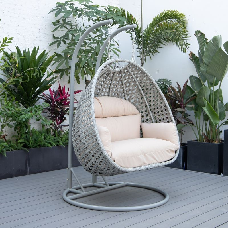 LeisureMod Mendoza Light Grey Wicker Hanging 2 Person Egg Swing Chair Beige on Patio.