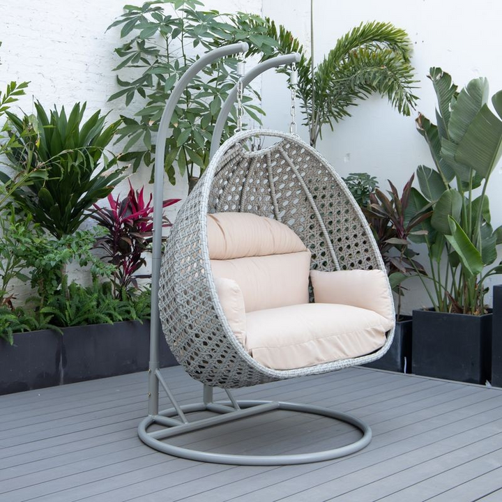 LeisureMod Mendoza Light Grey Wicker Hanging 2 Person Egg Swing Chair Beige on Patio.