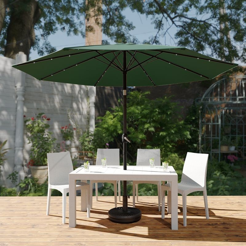 LeisureMod Sierra Outdoor Patio Umbrella with Base in Green Outside.