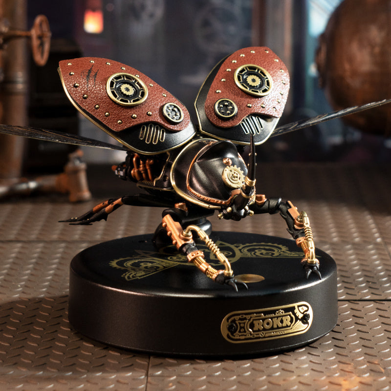 Steampunk-style ant figurine on a metallic surface with blurred background.