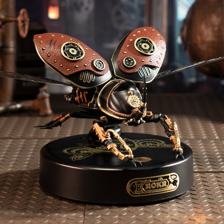 Steampunk-style ant figurine on a metallic surface with blurred background.