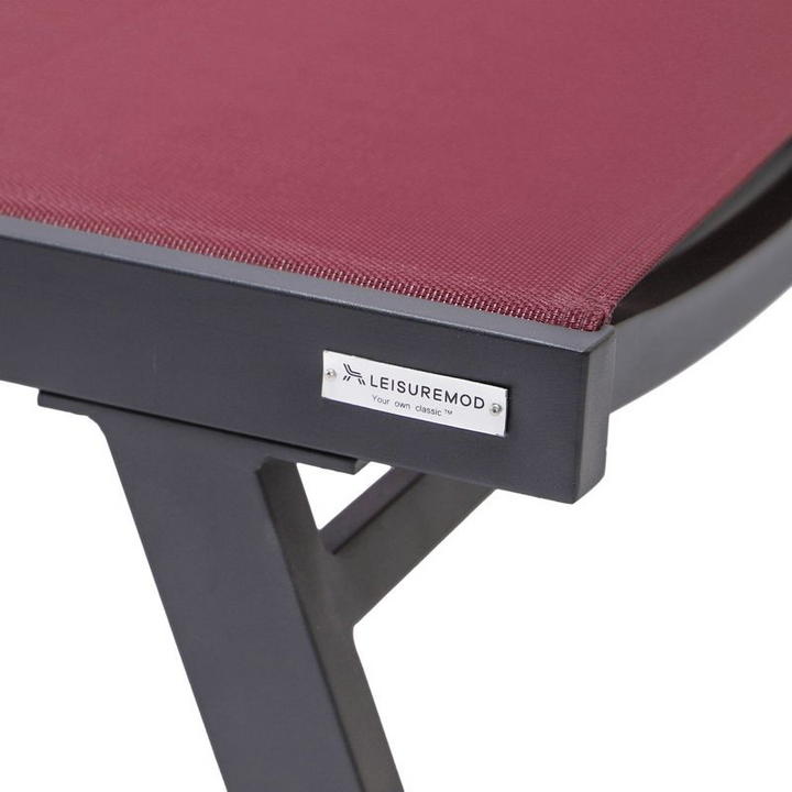 LeisureMod Marlin Patio Chaise Lounge Chair with Armrests in Black Aluminum Frame Burgundy Closeup.