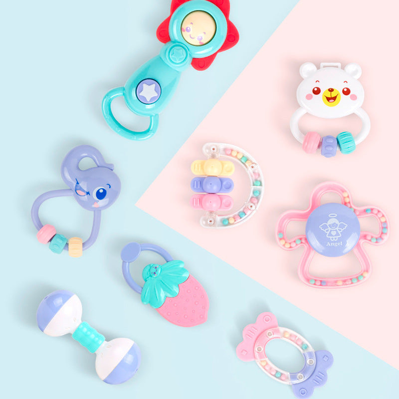 Collection of colorful baby toys on a pastel background.
