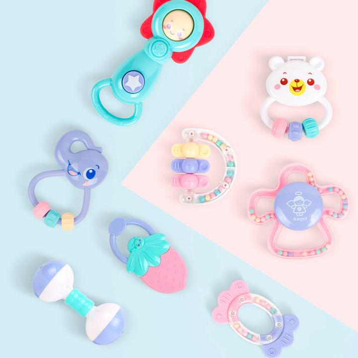 Collection of colorful baby toys on a pastel background.