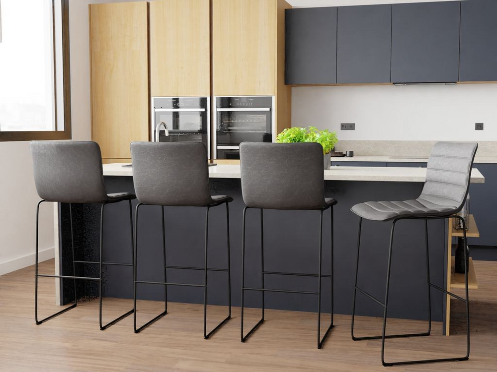 LeisureMod Brooklyn 29.9" Modern Leather Bar Stool with Black Iron Base and Footrest at Bar.