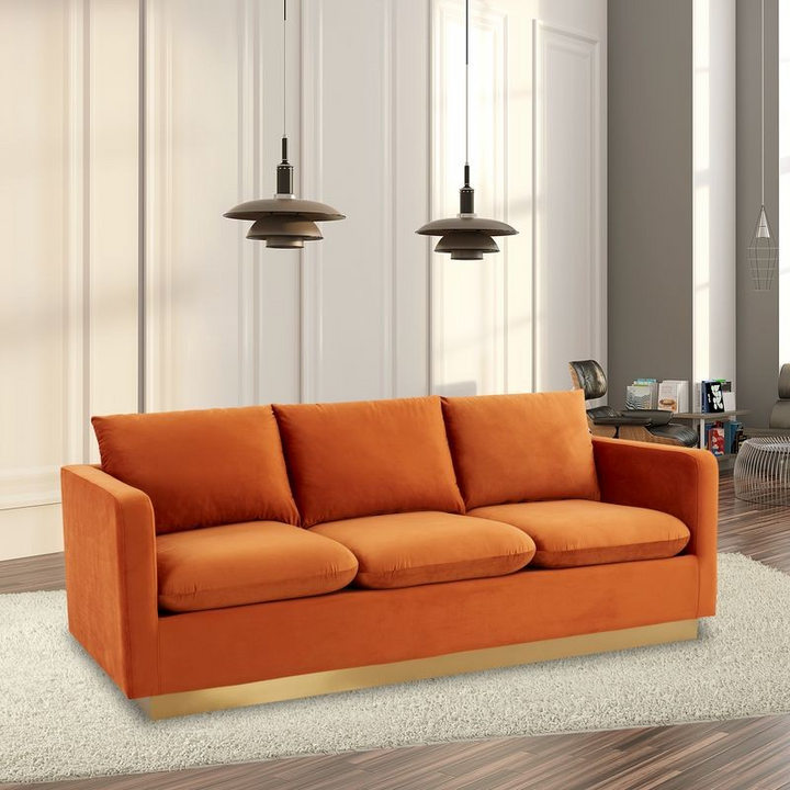 LeisureMod Nervo Modern Mid-Century Upholstered Velvet Sofa with Gold Frame Orange Marmalade with Background