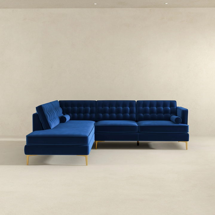 Blue sectional sofa on a beige floor with a plain wall background.