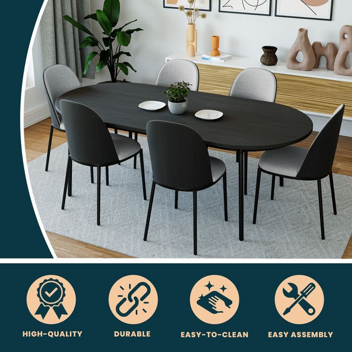 Dining room setup with a black oval table and six chairs in a modern interior setting.