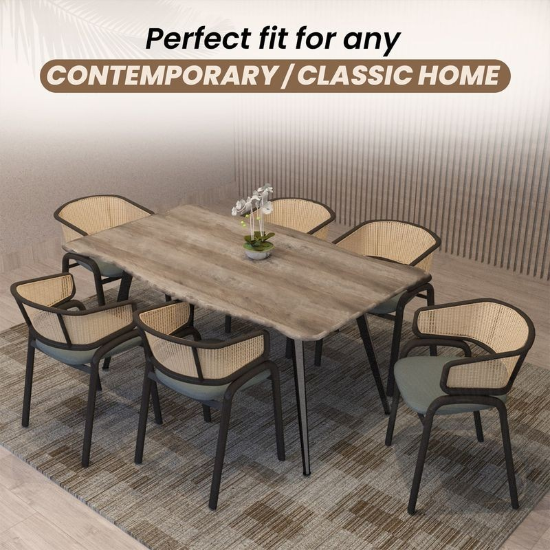 Dining table set with chairs in a room with a neutral color scheme.