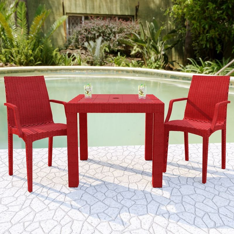 LeisureMod Weave Mace Indoor/Outdoor Chair (With Arms) Red at Table.