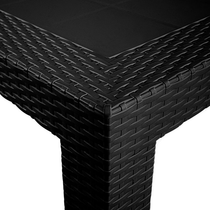 Black woven outdoor table corner on a white background.