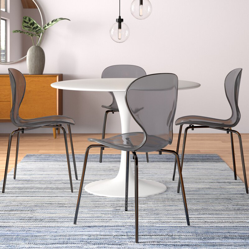 LeisureMod Modern Oyster Transparent Side Chair in Black Base set of 2 Black at Table.