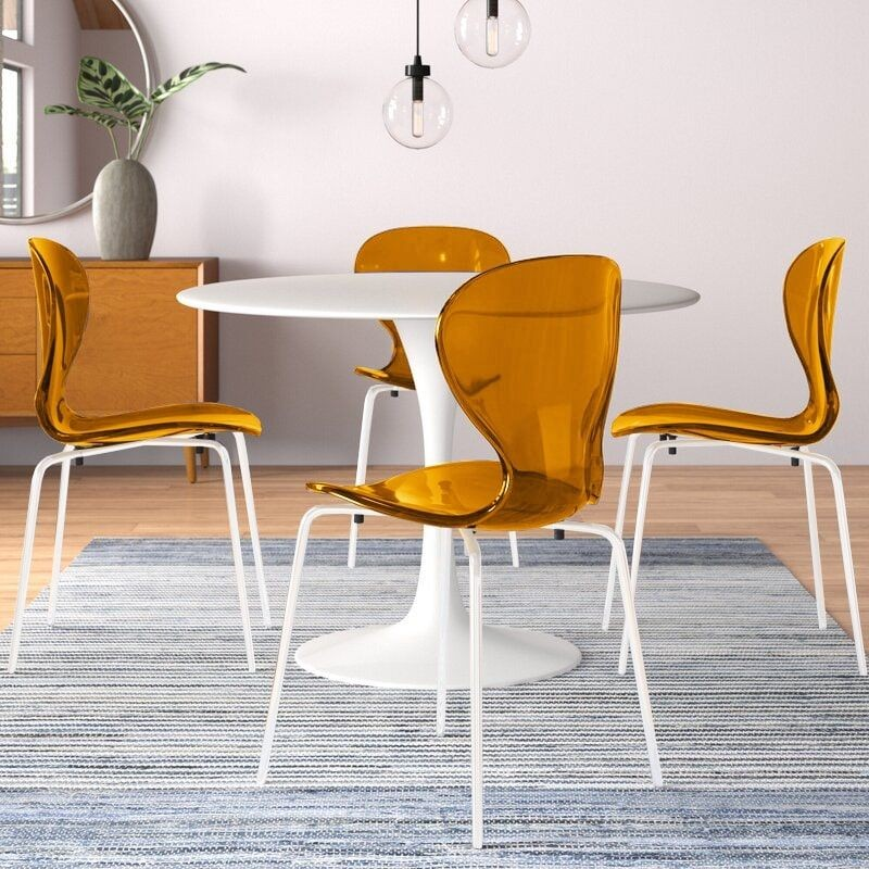 LeisureMod Modern Oyster Transparent Side Chair in White Base Set of 2 Orange at Table.