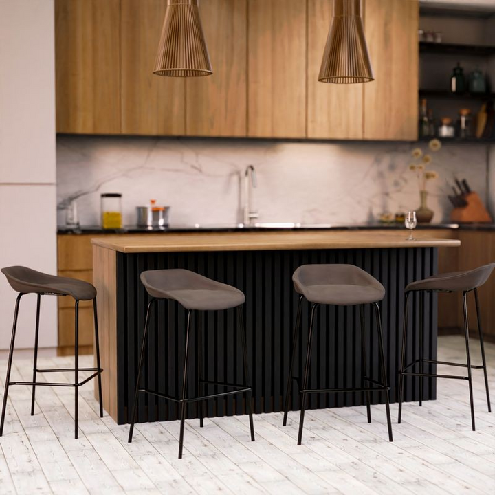 LeisureMod Servos Modern Barstool with Upholstered Faux Leather Seat and Powder Coated Iron Frame in Elephant Grey at Table.