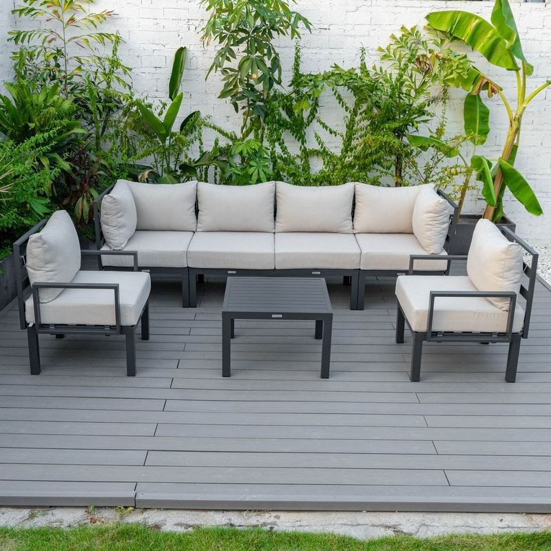 LeisureMod Chelsea 7-Piece Patio Sectional and Coffee Table Set Black Aluminum with Cushions Beige Photo.