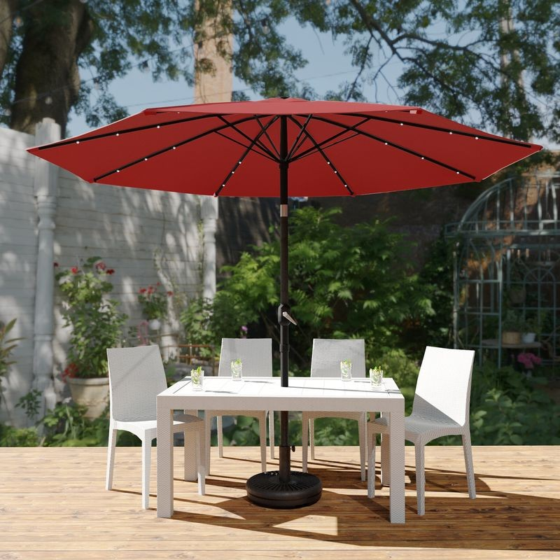 LeisureMod Sierra 9' Outdoor Patio Tilt Market Umbrella with Solar LED Lights Red Outside.