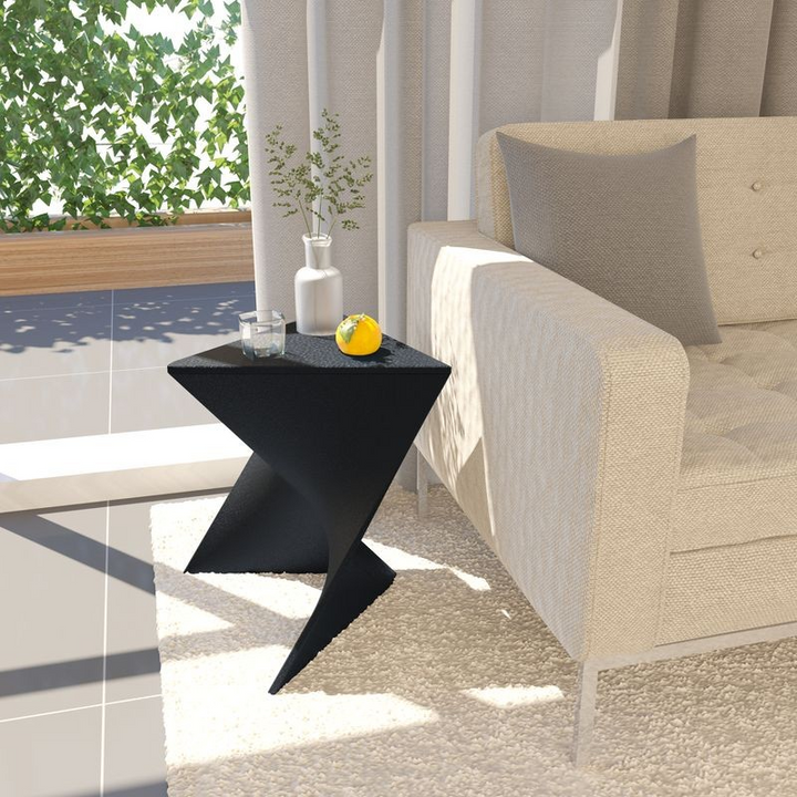 Black side table with decorative items next to a beige sofa on a patio.