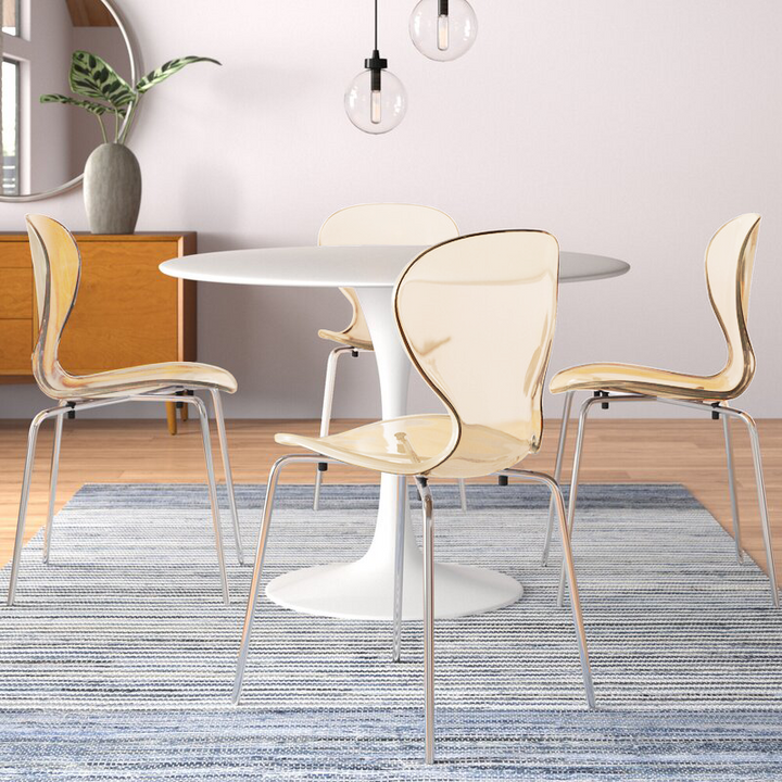 LeisureMod Modern Oyster Transparent Side Chair Amber at Table.