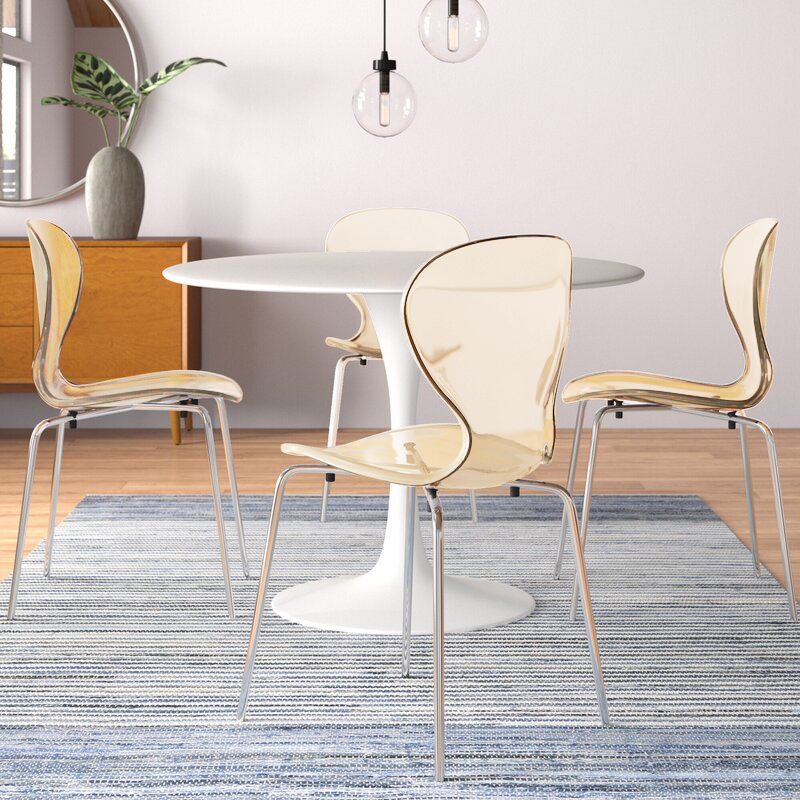 LeisureMod Modern Oyster Transparent Side Chair Amber at Table.