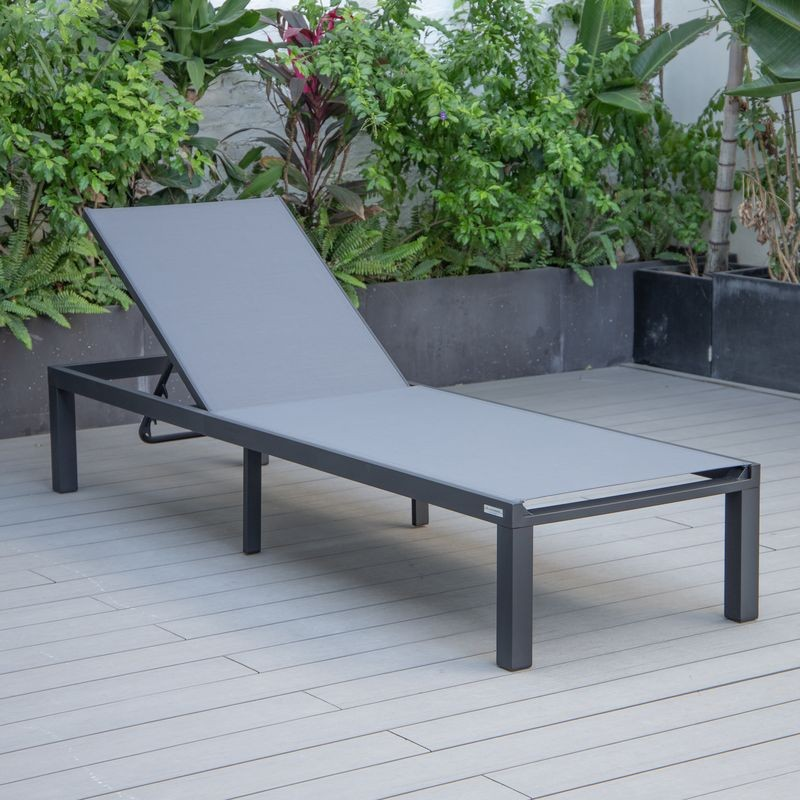 LeisureMod Marlin Patio Chaise Lounge Chair with Black Aluminum Frame Dark Grey on Deck.