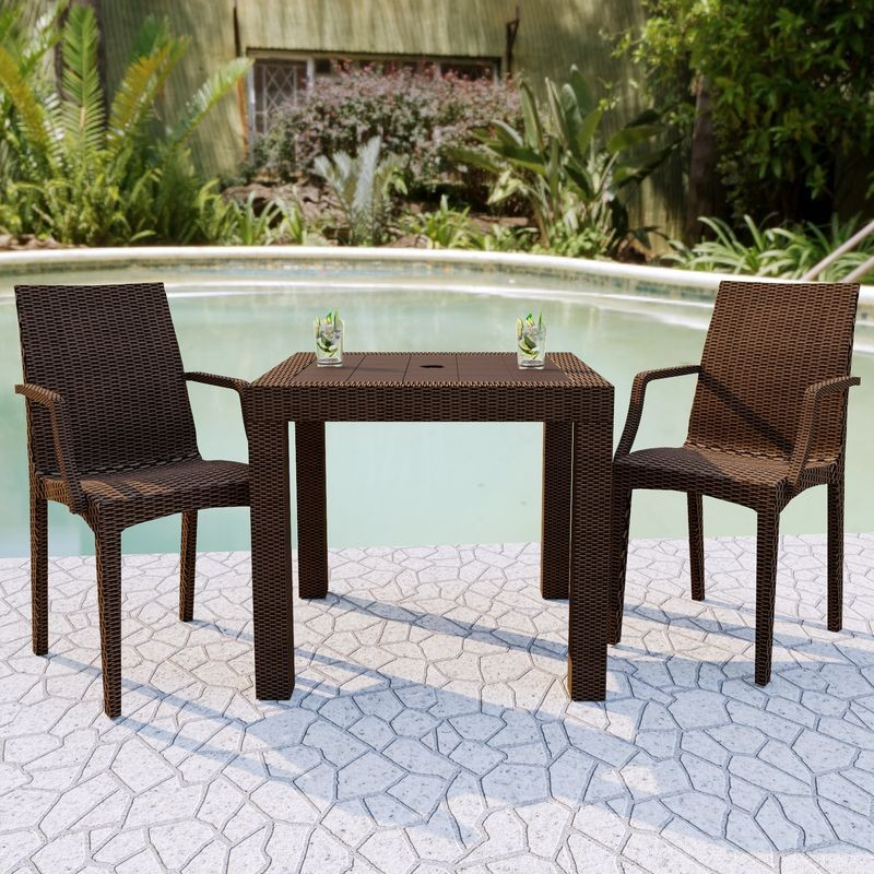 LeisureMod Weave Mace Indoor/Outdoor Chair (With Arms) Brown at Table.