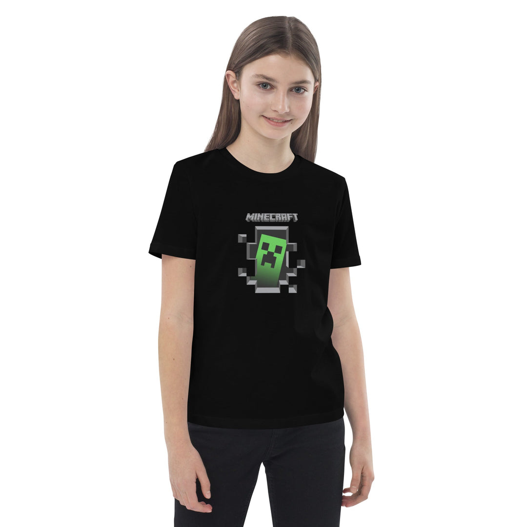Girl wearing a black t-shirt with a Minecraft creeper graphic on a white background.