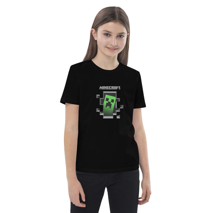 Girl wearing a black t-shirt with a Minecraft creeper graphic on a white background.