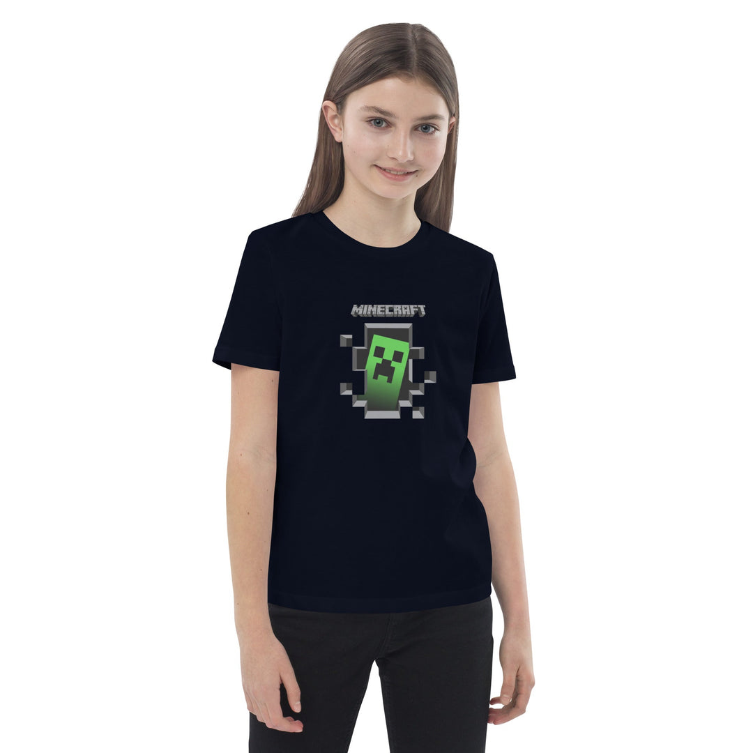 Girl wearing a black t-shirt with a Minecraft creeper graphic on a white background.