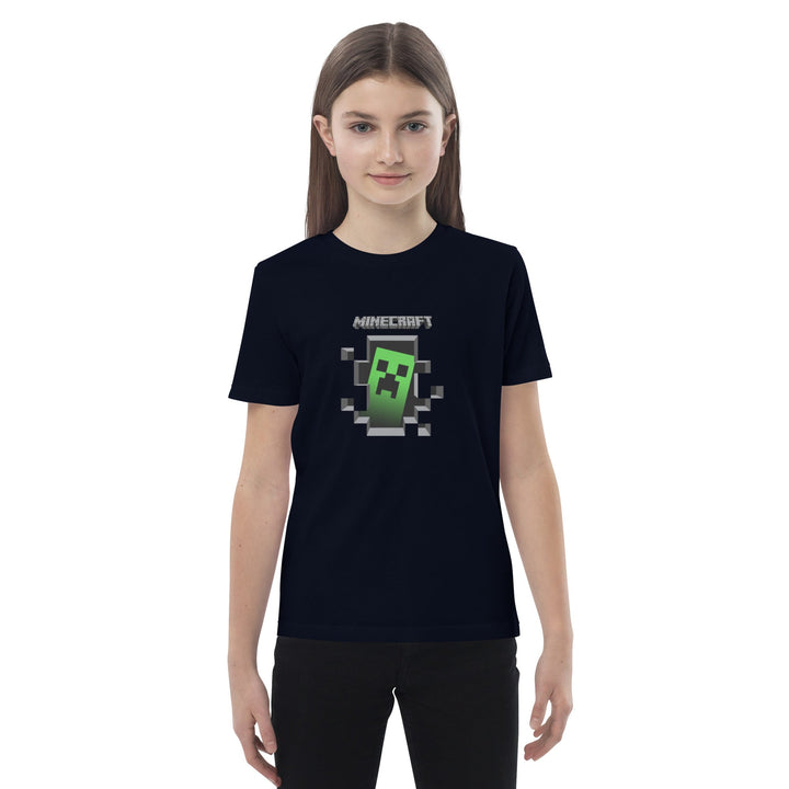 Person wearing a black t-shirt with a Minecraft logo on a white background.