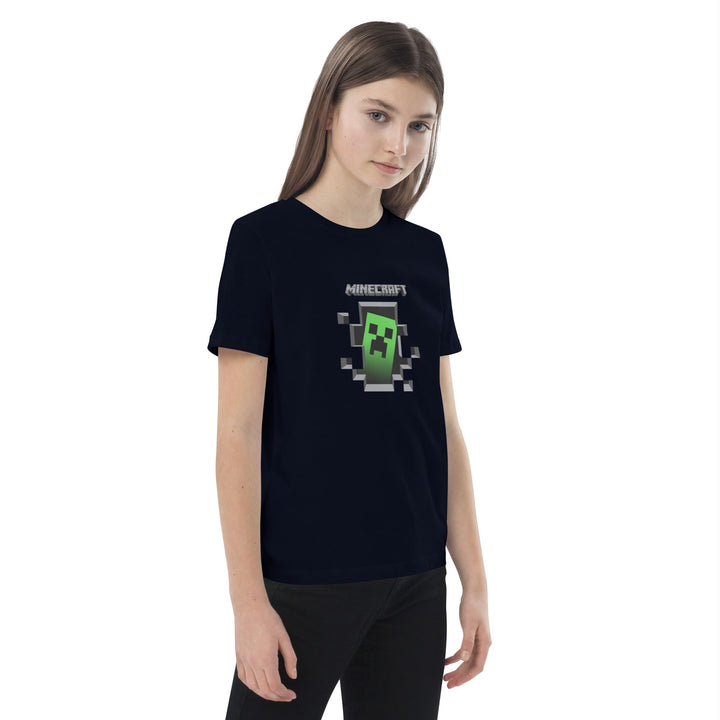 Person wearing a black t-shirt with a Minecraft creeper graphic on a white background.