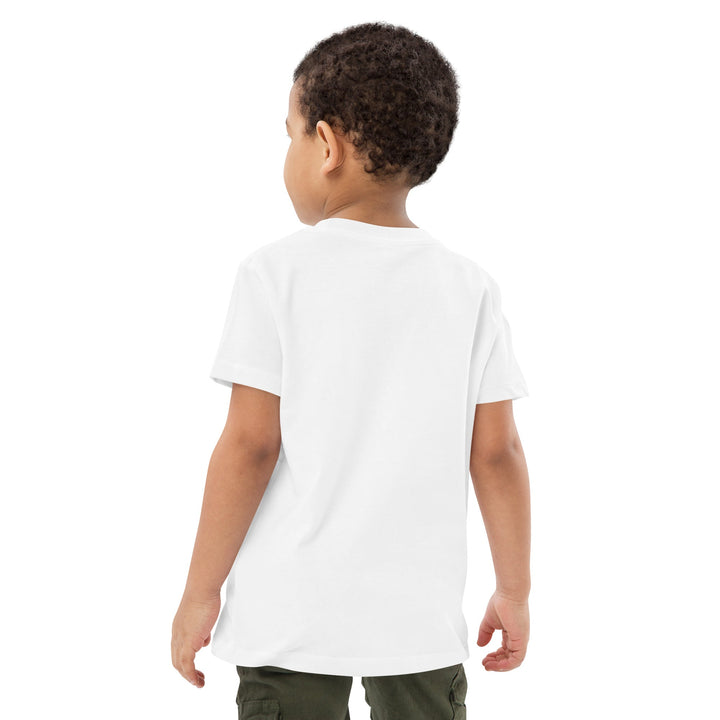 Child wearing a white t-shirt on a white background.