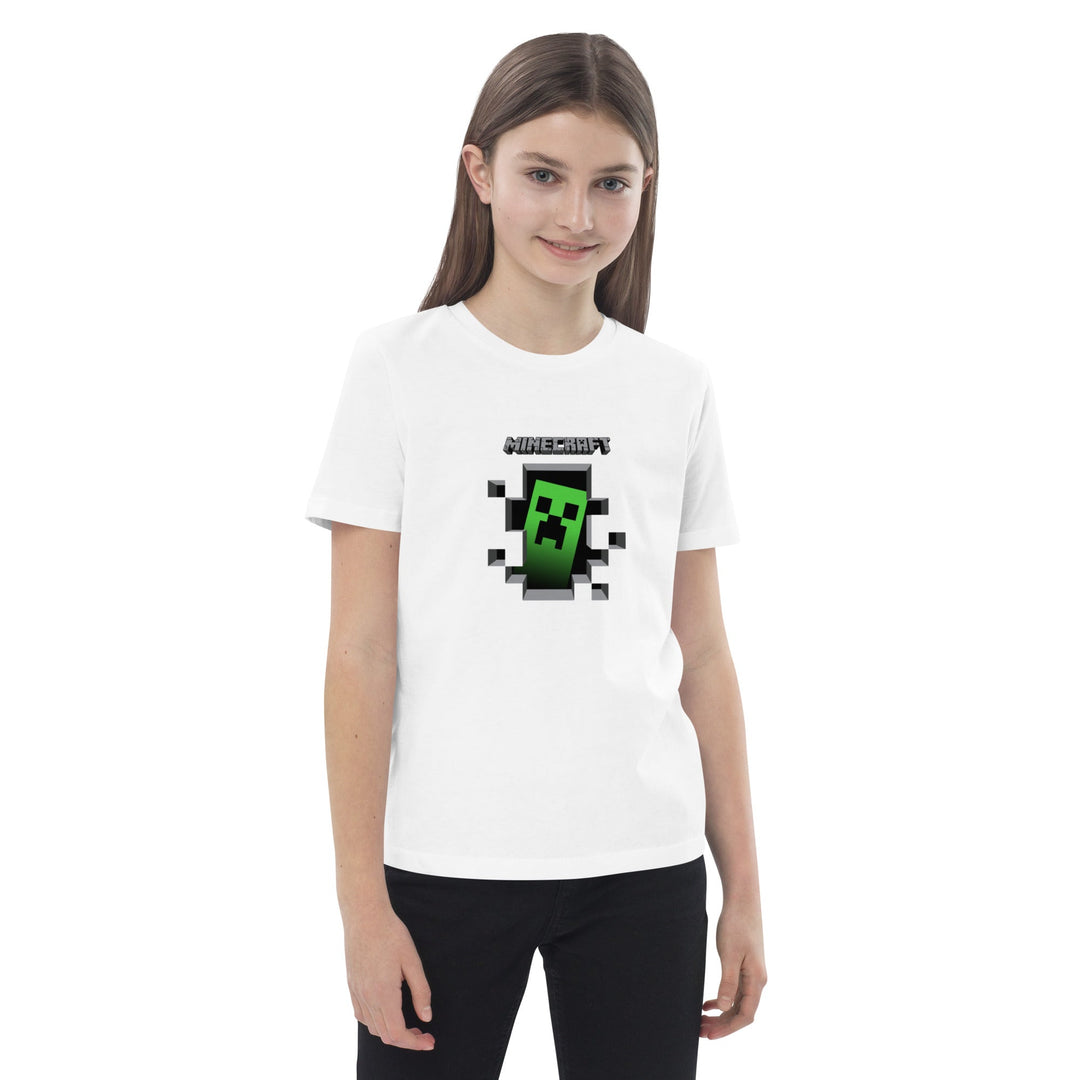 Girl wearing a white t-shirt with a Minecraft creeper design on a white background.