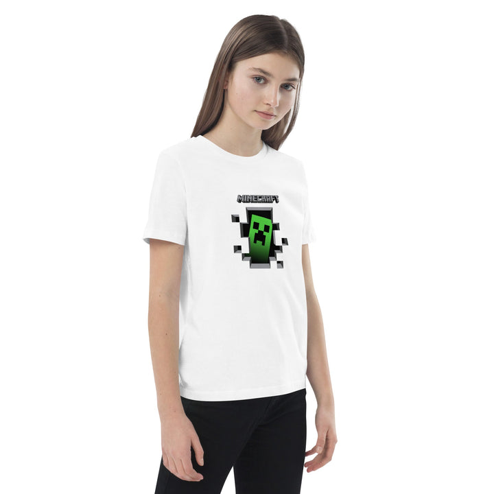 Person wearing a white t-shirt with a pixelated character design on a white background.
