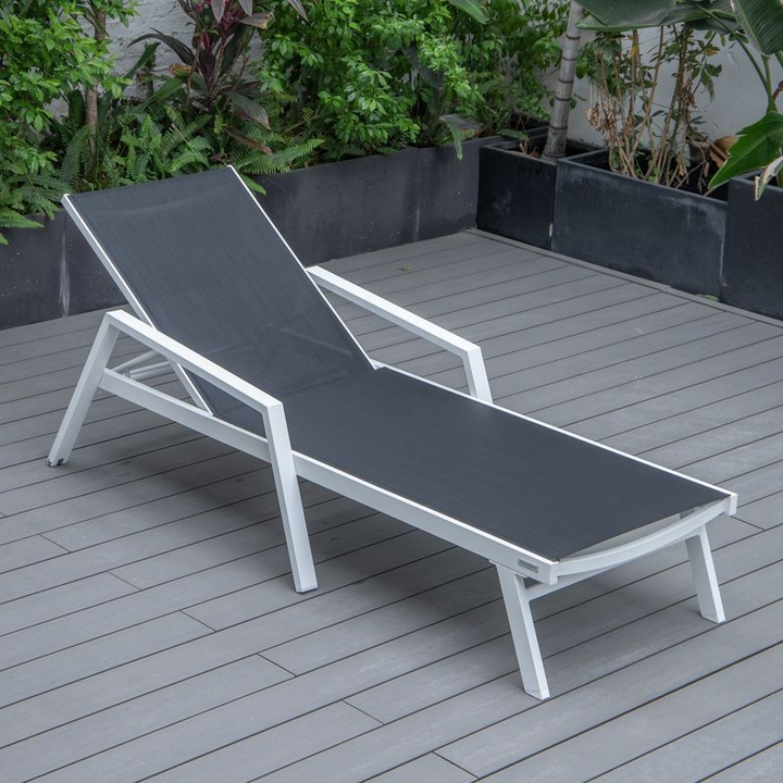 LeisureMod Marlin Patio Chaise Lounge Chair with Armrests in White Aluminum Frame Black Photo.