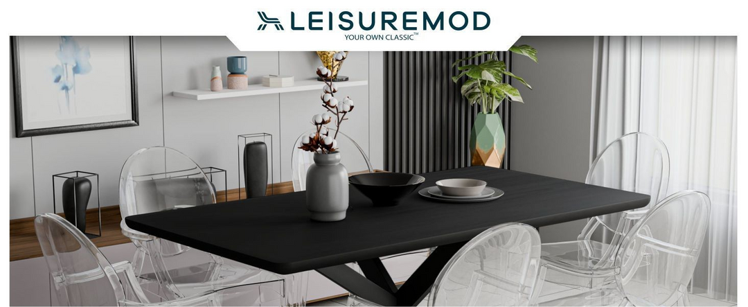 Dining room setup with black table and transparent chairs, featuring LeisureMod brand.
