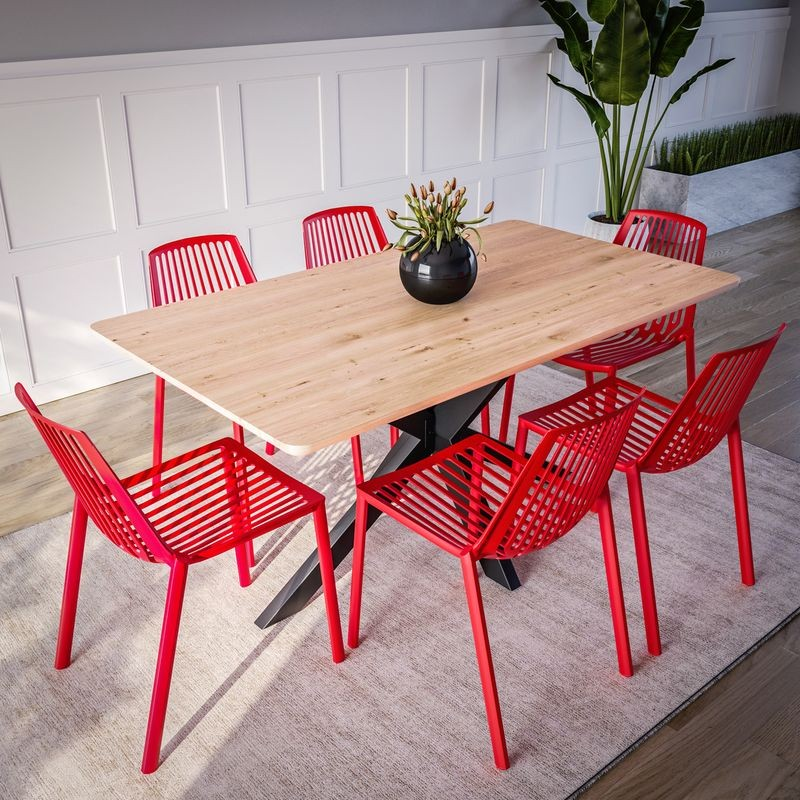 LeisureMod Acken Plastic Stackable Dining Chair Red at Table.