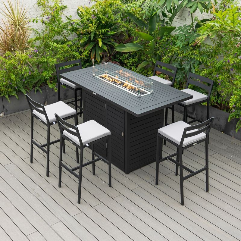 Outdoor patio set with fire pit table and chairs on a wooden deck.